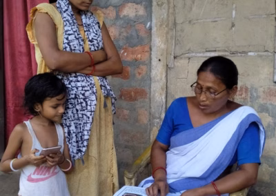 ASHA health worker communicating at a household